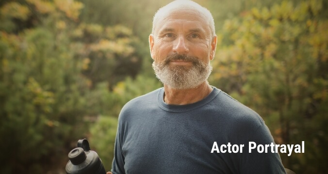 Older gentleman holding a water bottle. Actor portrayal